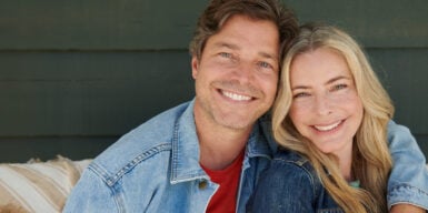 Woman and man over 50 smiling into camera as a couple
