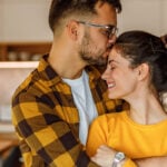 Man holding woman in his arms as a symbol of how to be a good boyfriend