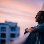 man looking into the vastness from a tower when he pulls away