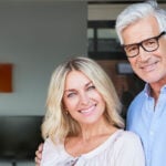 Senior couple smiling into camera as a symbol of senior dating