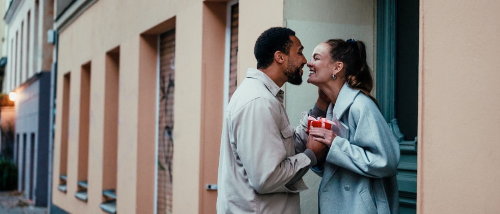 a couple kissing, looking into each others eyes