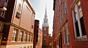 Old North Church in Boston, next to two red brick buildings
