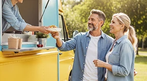 A couple getting food from a food truck.