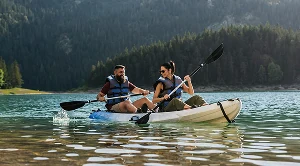 A couple kayaking on a lake. 