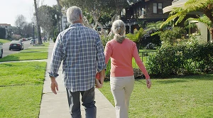 A couple walking in the neighborhood.