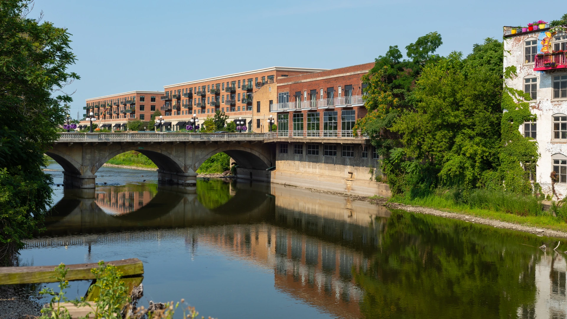 Views of buildings in Arlington with a river and a bridge.