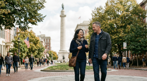 A couple in front of the washington monument in baltimore.