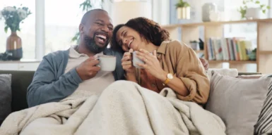Couple on the couch laughing and having a good time