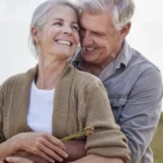 A couple hugging each other in the nature.