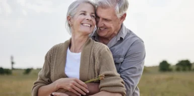 A couple hugging each other in the nature.
